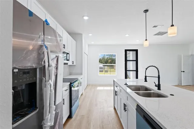 a kitchen with refrigerator a sink and cabinets