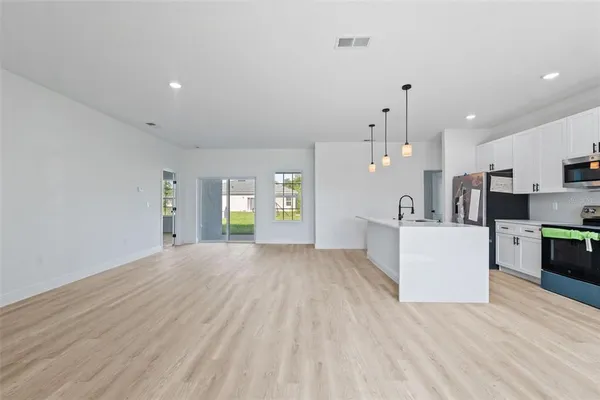 a view of a kitchen with microwave and cabinets