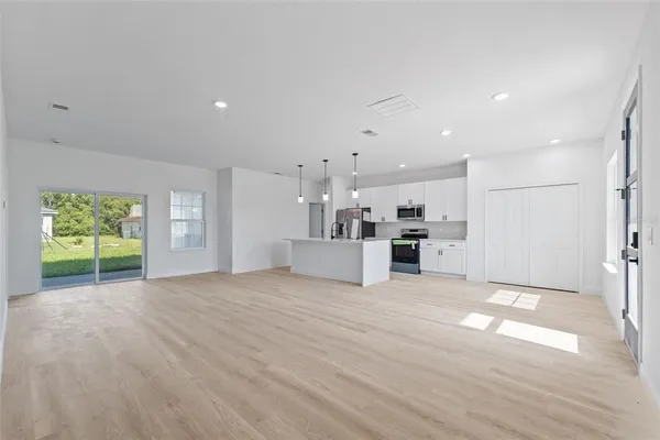 a view of a kitchen with a sink and a large window