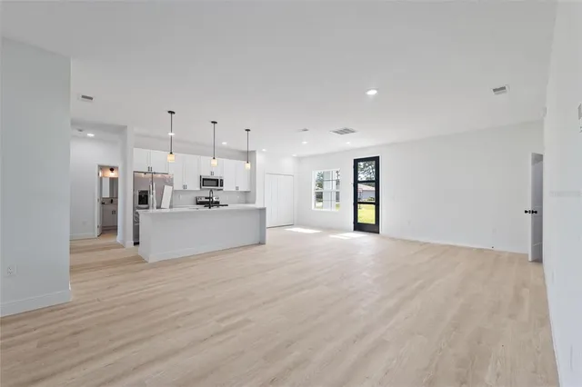 a view of a kitchen with a sink and a refrigerator