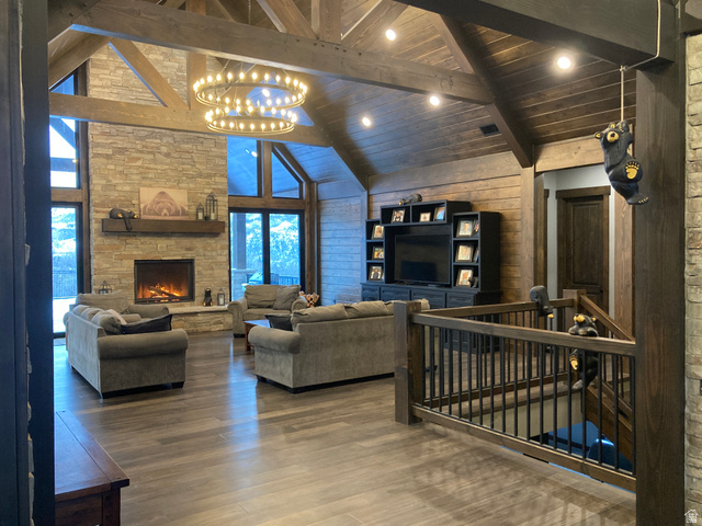 259 Meadow Drive Springville, UT 84663 - Photo 10 of 62 Living room with a high wooden beamed ceiling, wood finished floors, hanging lights, a fireplace, and wood walls