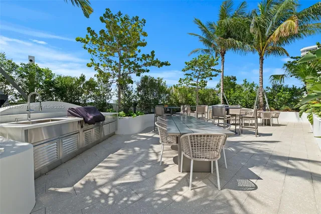 a view of a patio with table and chairs potted plants with wooden floor