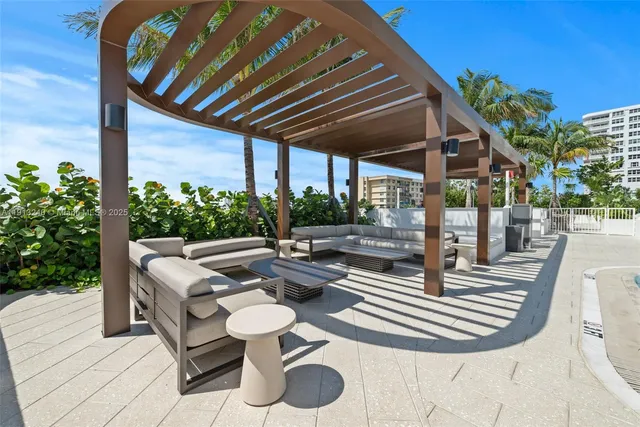 a view of a swimming pool with outdoor seating