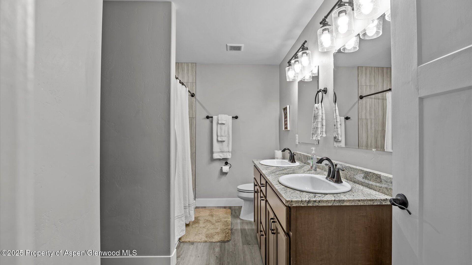 137 Willow Circle Rifle, CO 81650 - Photo 13 of 25 a bathroom with a sink vanity granite and a mirror