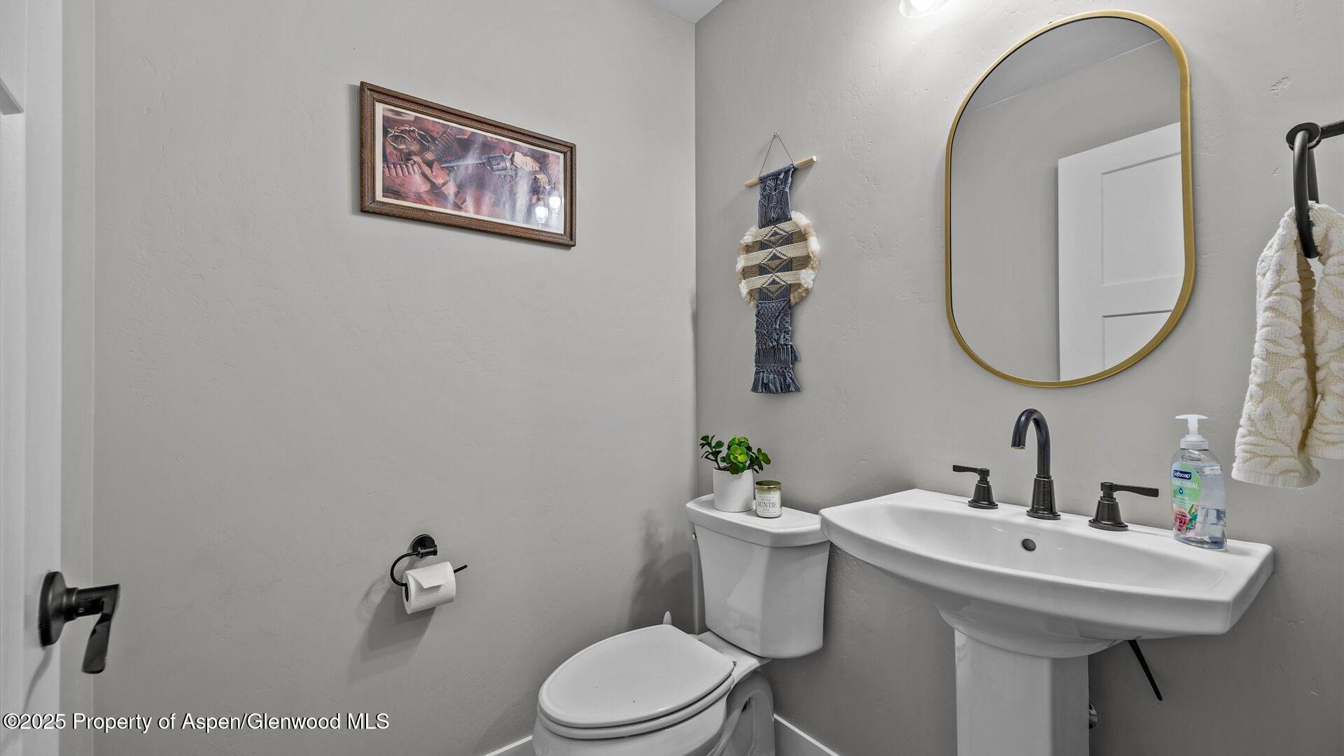 137 Willow Circle Rifle, CO 81650 - Photo 18 of 25 a bathroom with a toilet a sink and mirror