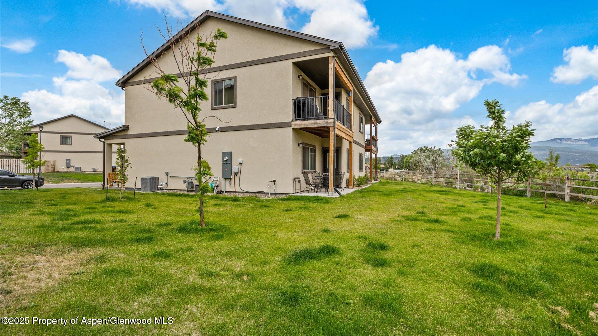 137 Willow Circle Rifle, CO 81650 - Photo 23 of 25 a view of a big house with a big yard and large trees
