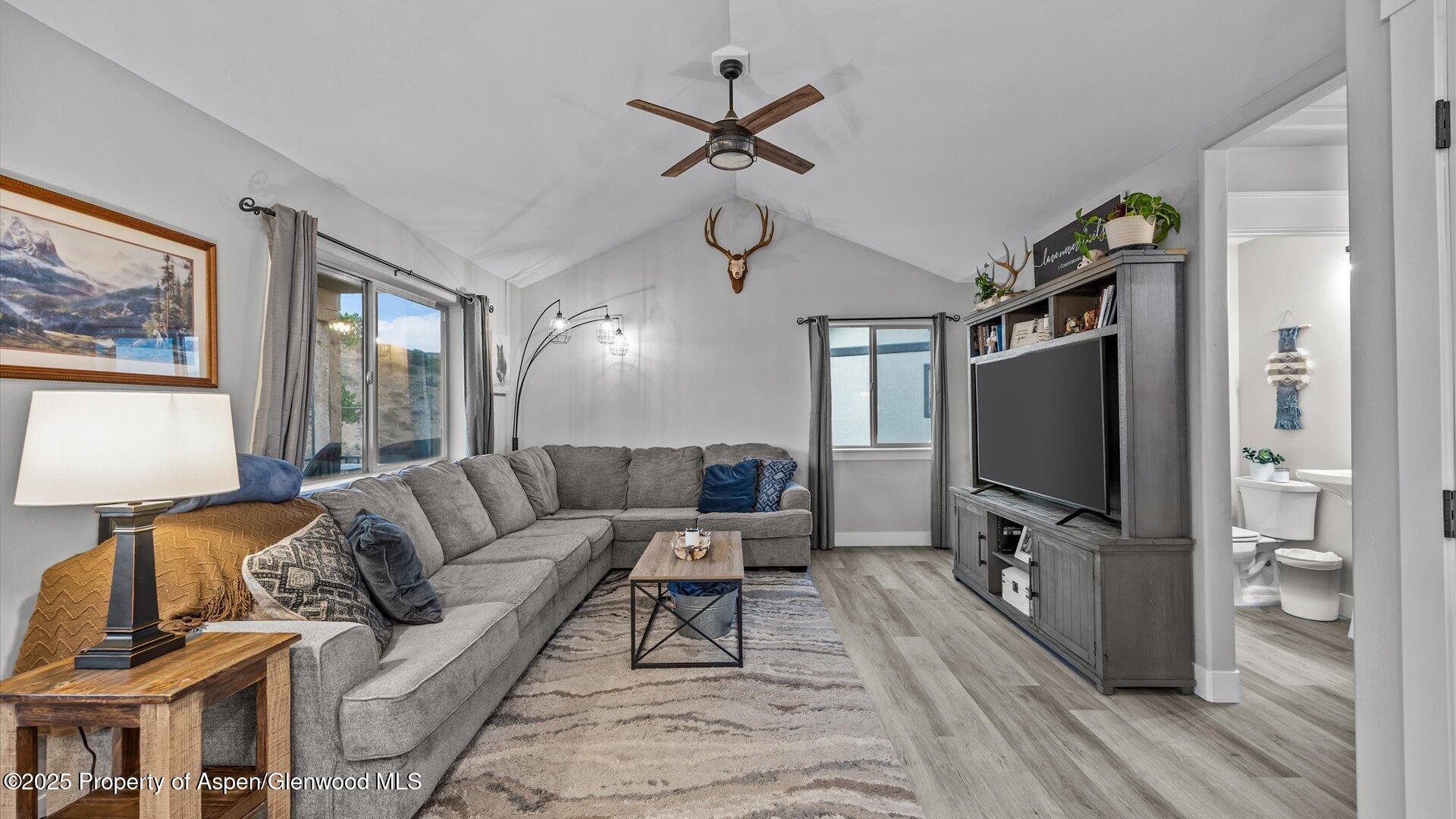 137 Willow Circle Rifle, CO 81650 - Photo 5 of 25 a living room with furniture a ceiling fan and a flat screen tv
