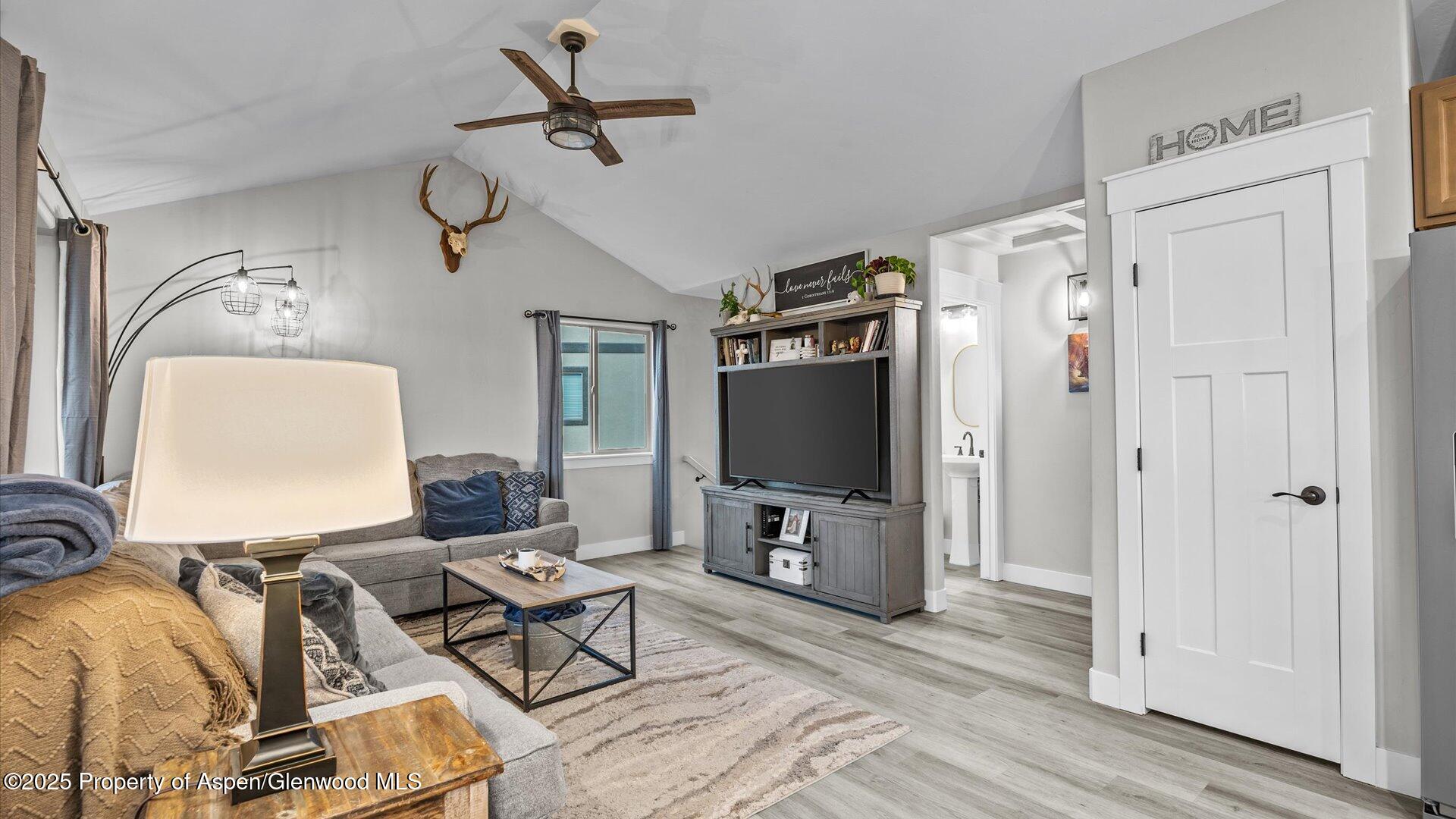 137 Willow Circle Rifle, CO 81650 - Photo 6 of 25 a living room with furniture a flat screen tv and a window
