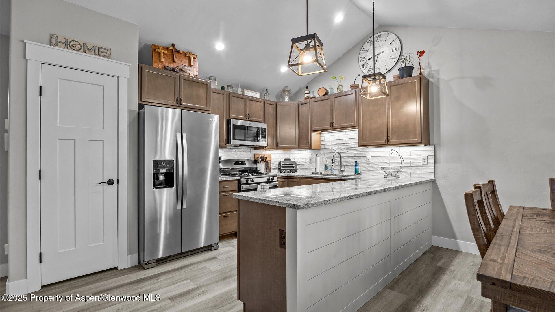 137 Willow Circle Rifle, CO 81650 - Photo 9 of 25 a kitchen with stainless steel appliances granite countertop a sink refrigerator and cabinets