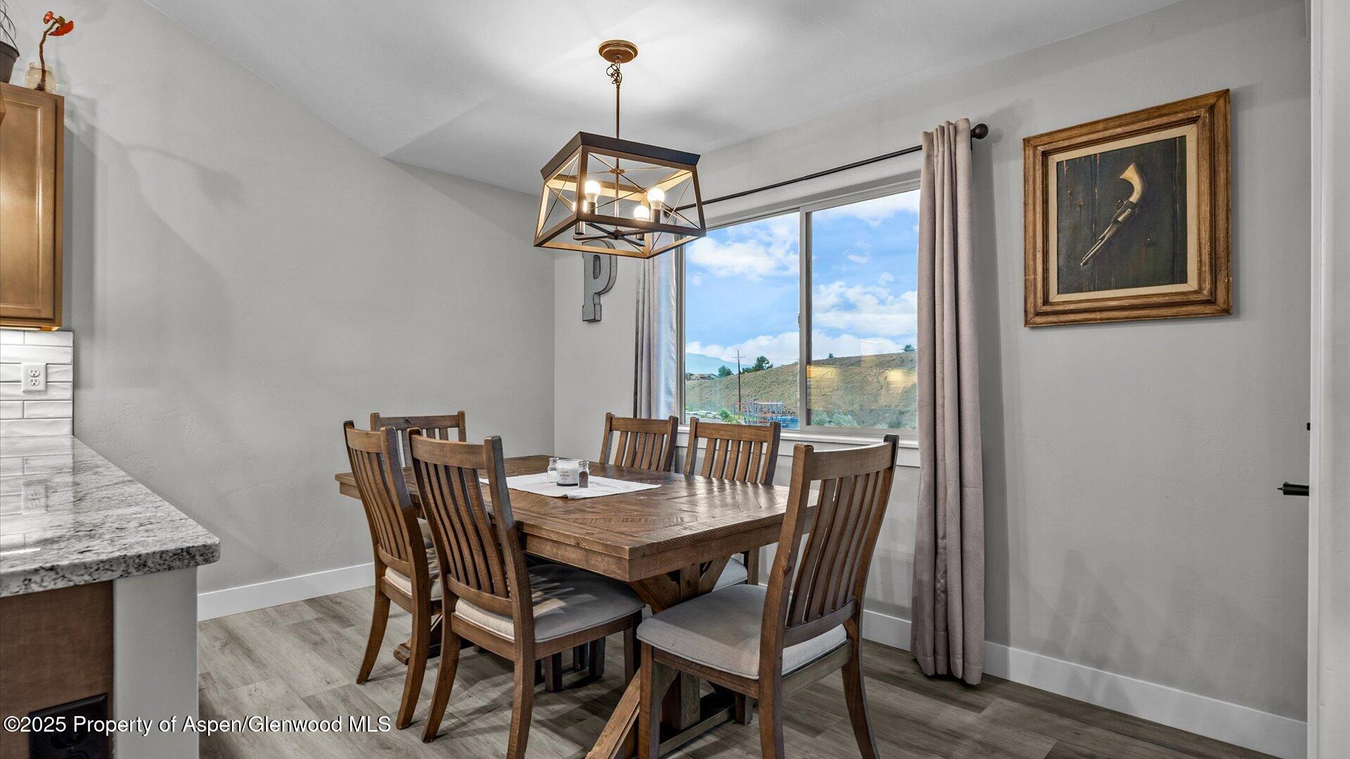 137 Willow Circle Rifle, CO 81650 - Photo 10 of 25 a view of a dining room with furniture wooden floor and chandelier