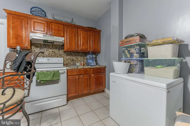 a kitchen with a stove top oven and cabinets