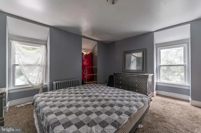 a bedroom with a large bed and a window