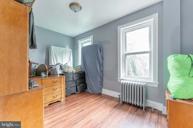 a kitchen with stainless steel appliances granite countertop a stove a refrigerator a sink dishwasher and wooden cabinets with wooden floor