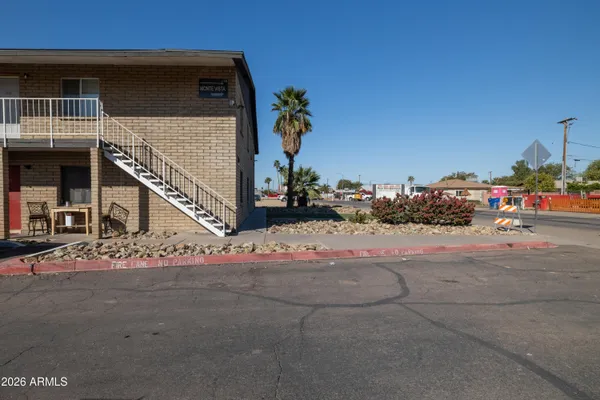 a view of street along with house and car parked