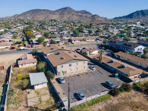 an aerial view of a house with a mountain