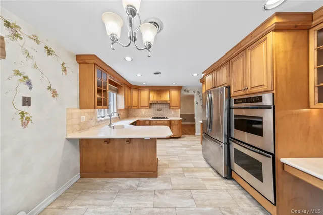 a kitchen with stainless steel appliances a sink stove and refrigerator