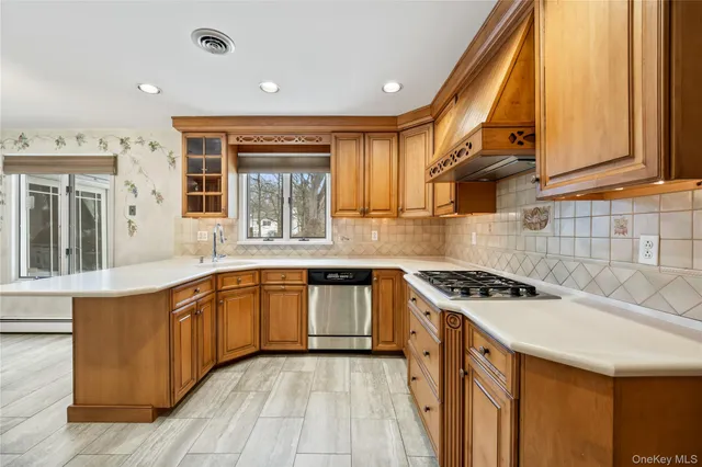 a kitchen with stainless steel appliances granite countertop a stove a sink and a microwave