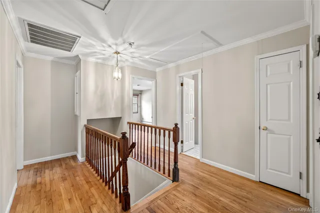 a view of a hallway with entryway wooden floor and front door