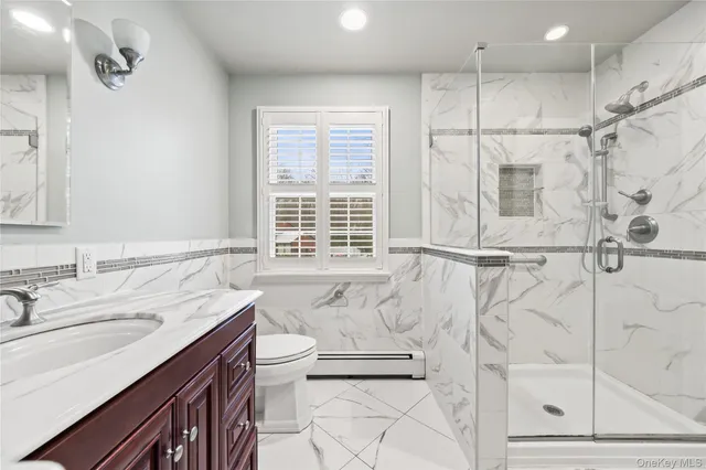 a bathroom with a sink double vanity and a shower