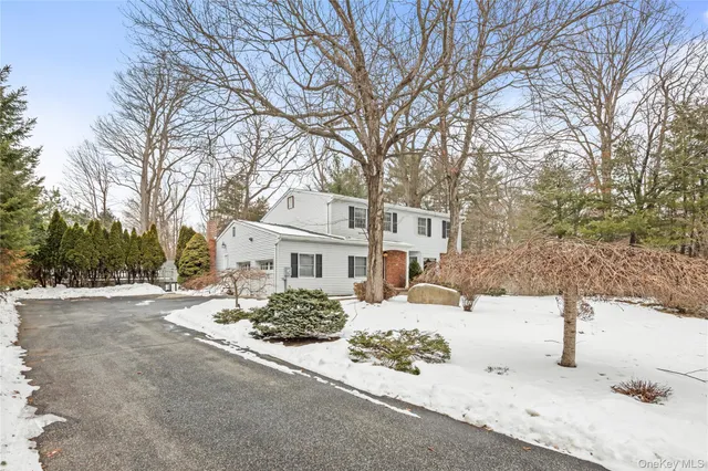 a front view of a house with a yard covered in snow