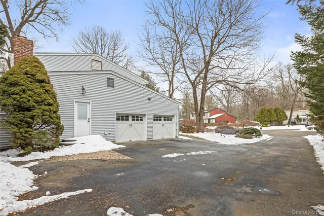 a view of a house with a yard and trees