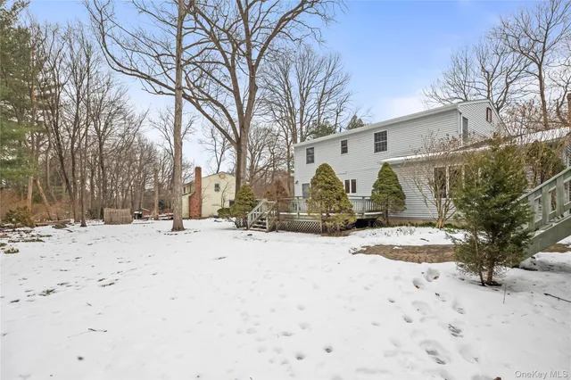 a view of a white house with a snow of the road