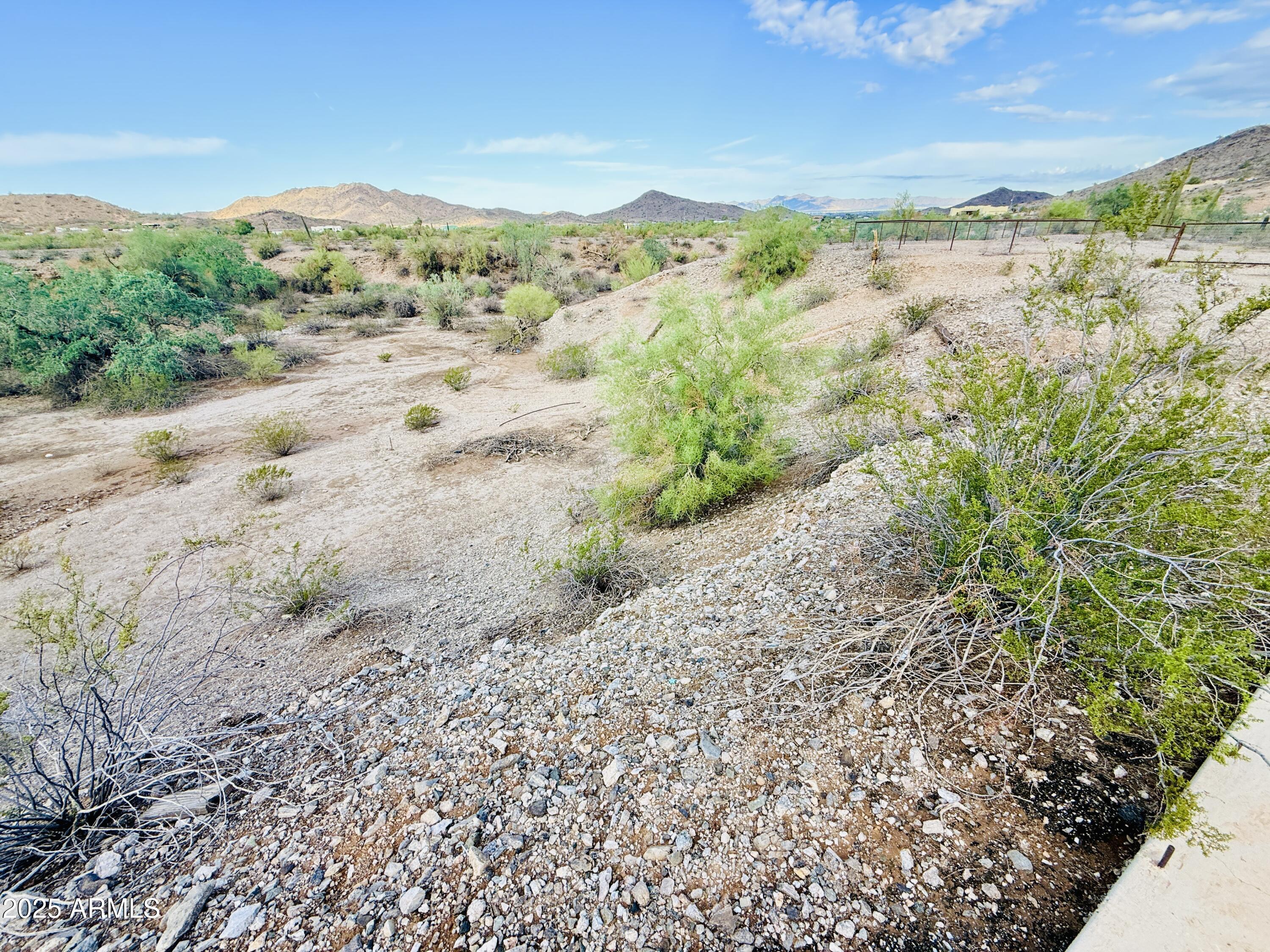 9080 South 138th Avenue Goodyear, AZ 85338 - Photo 13 of 20 a view of a field with mountains in the background