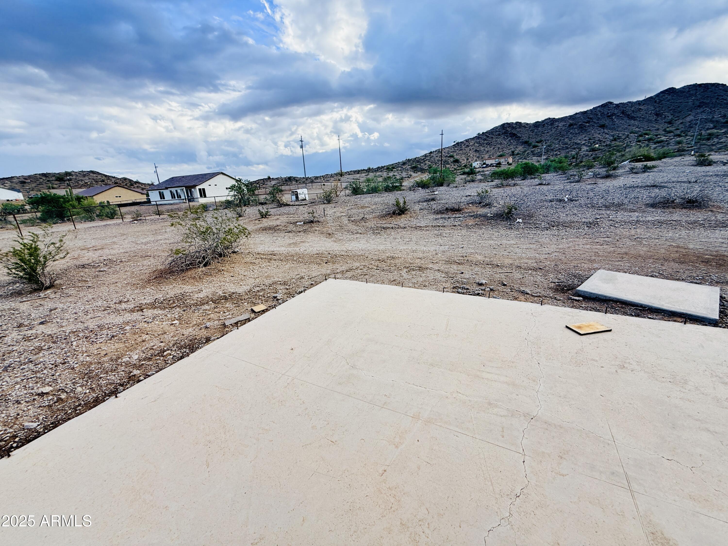 9080 South 138th Avenue Goodyear, AZ 85338 - Photo 15 of 20 a view of a dry yard with wooden fence