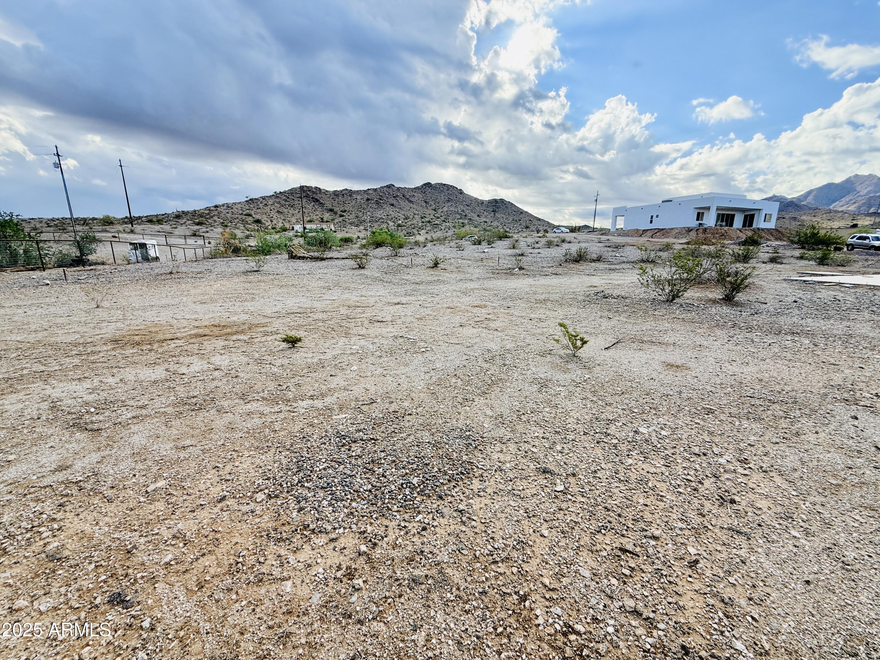 9080 South 138th Avenue Goodyear, AZ 85338 - Photo 16 of 20 a view of a dry yard with wooden fence