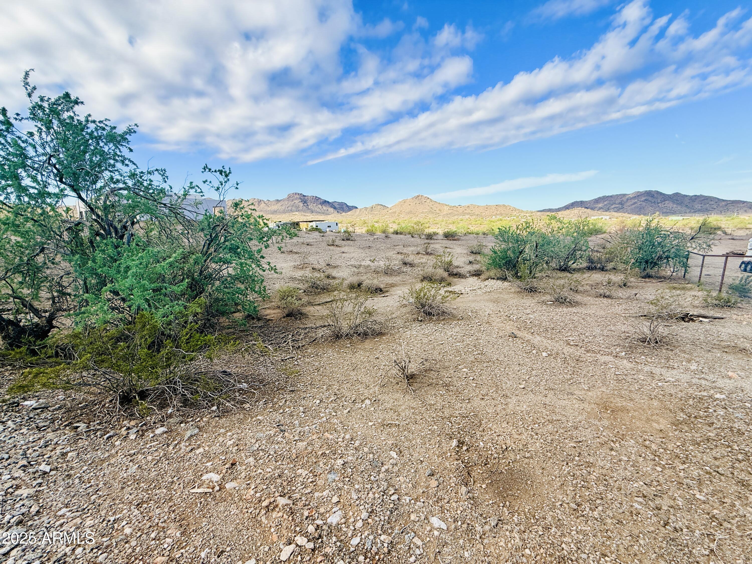 9080 South 138th Avenue Goodyear, AZ 85338 - Photo 17 of 20 a view of a dry yard with mountains in the background