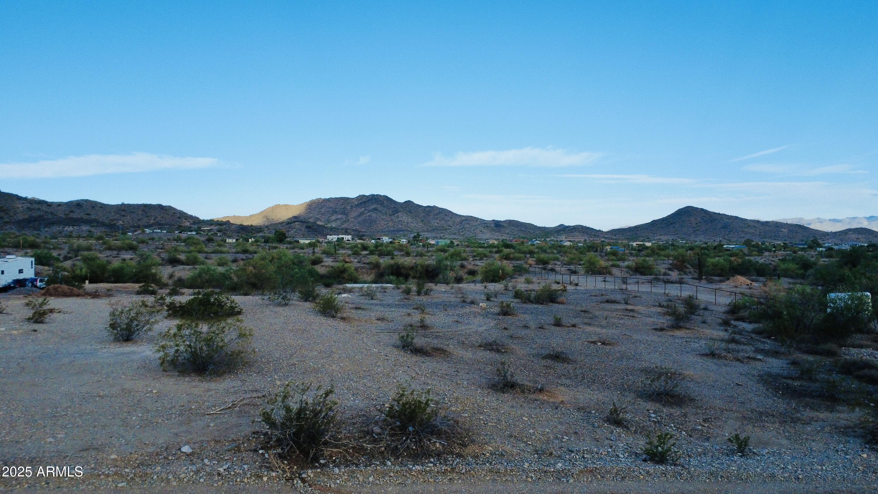 9080 South 138th Avenue Goodyear, AZ 85338 - Photo 10 of 20 a view of a dry field with mountains in the background
