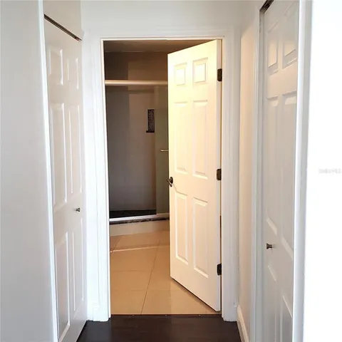 a view of a hallway with wooden floor