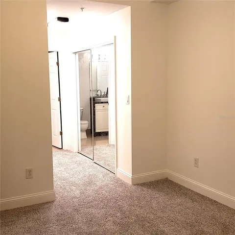 a bathroom with a granite countertop shower and a toilet