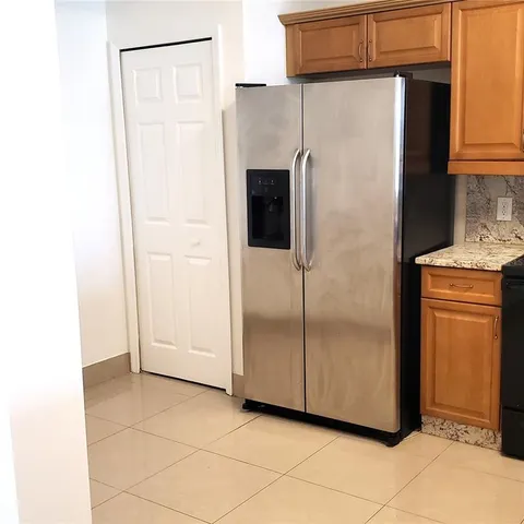 a kitchen with granite countertop a stove and a sink