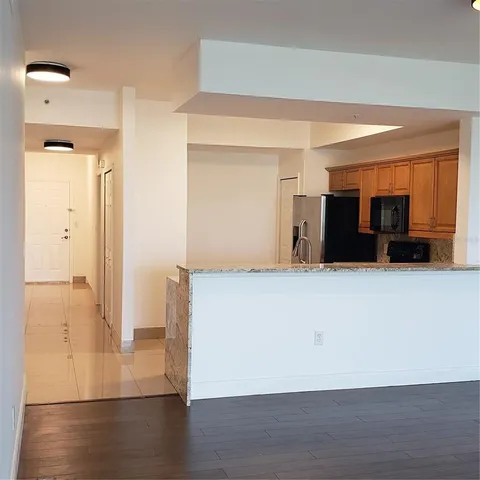 a kitchen with stainless steel appliances a refrigerator and a microwave