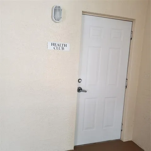 a vase of flowers sitting on a floor in front of a window