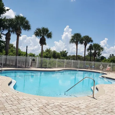 a view of a swimming pool with a lounge chair