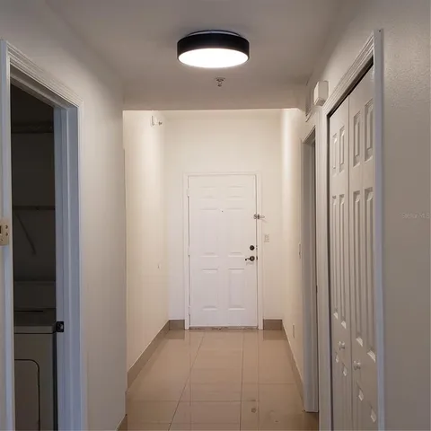 a view of a room with a sink and a mirror