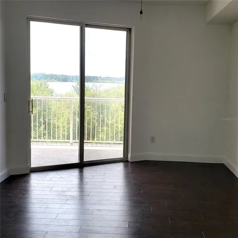 a view of room with window and wooden floor