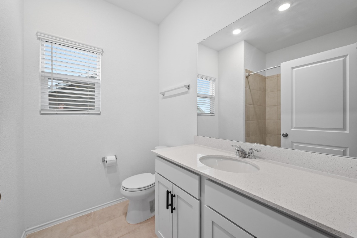 167 Rioja Kyle, TX 78640 - Photo 18 of 26 a bathroom with a granite countertop sink a toilet and a mirror