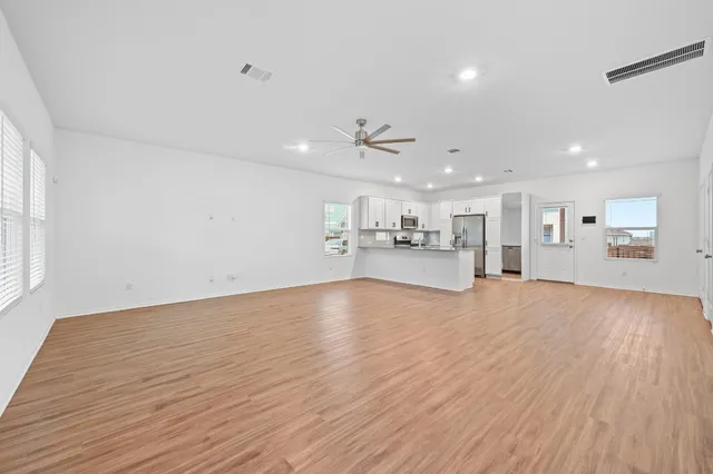 a view of kitchen and hall with wooden floor