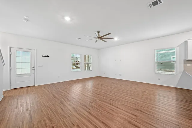 wooden floor in an empty room with a window