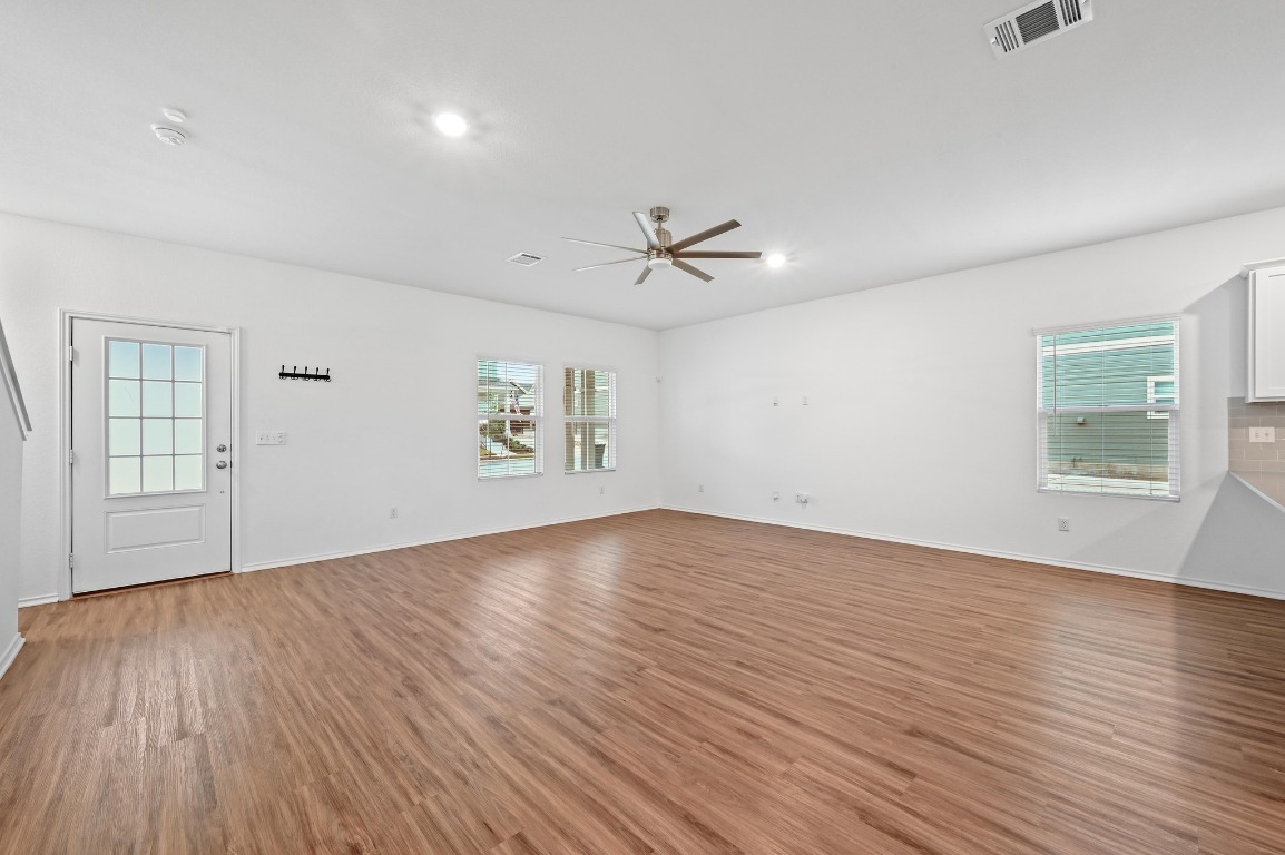 167 Rioja Kyle, TX 78640 - Photo 8 of 26 wooden floor in an empty room with a window