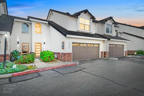 a front view of a house with a yard and a garage