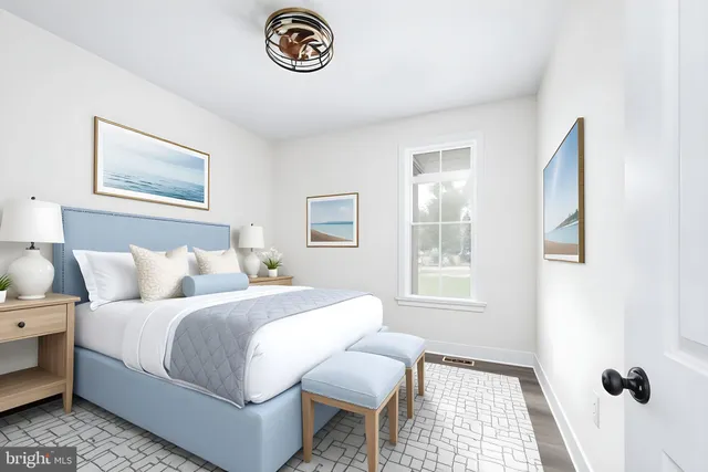 an empty room with a hardwood and windows