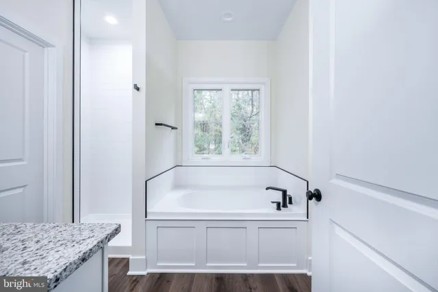 a white bath tub sitting next to a window
