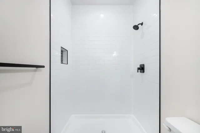 a view of room with walk in closet and wooden floor