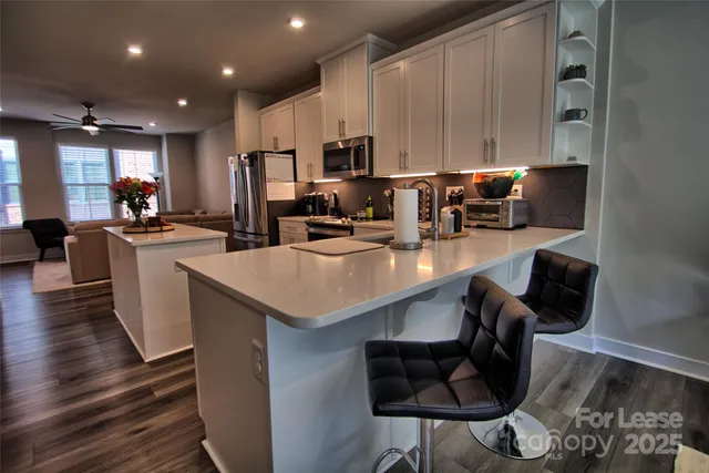a kitchen with stainless steel appliances granite countertop a sink counter space and cabinets