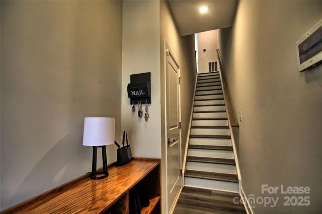 a view of a room with wooden floor and stairs