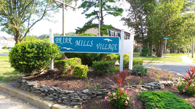 a view of a street sign under a large tree